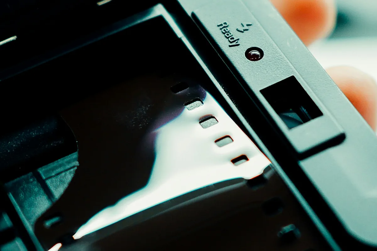 Tira de película de 35 mm cargada en un aparato con la tapa abierta